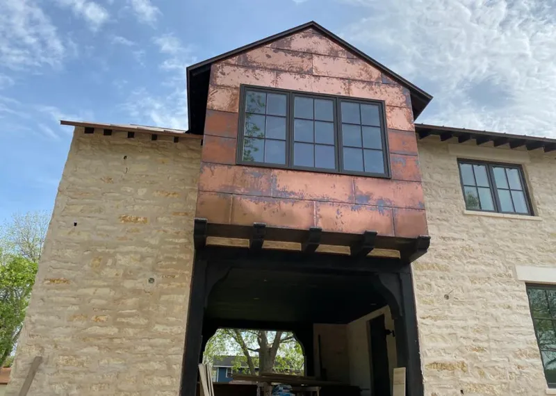 Copper metal panel facade on a stone building for Roof Repair in Norcross