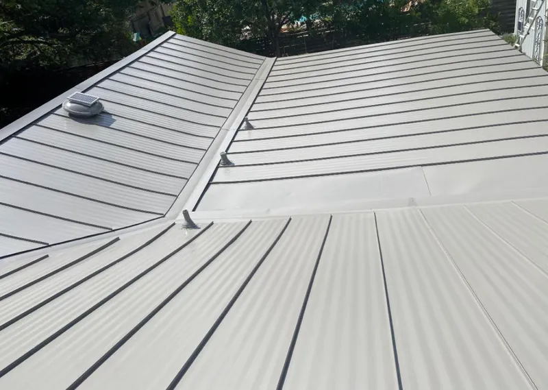 Solar attic fan installed on a metal roof for Roof Ventilation in Norcross